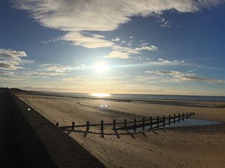 Sun setting over Rhyl beach