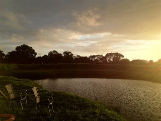 Llwyn Fynnon Caravan Park, Pwllheli fishing lake at sunset