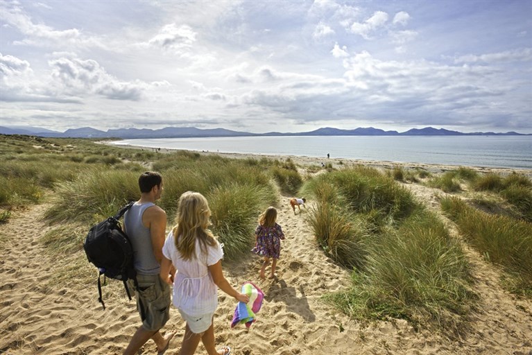 Walking through sand dunes towards Newborough beach